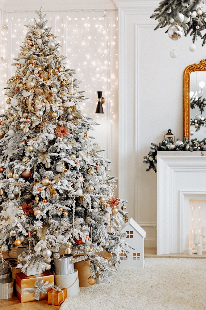Flocked tree with gold Christmas ornaments