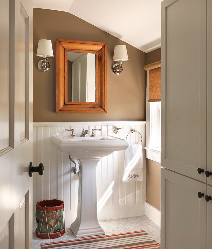 Cozy bathroom with wainscoting and eave ceiling