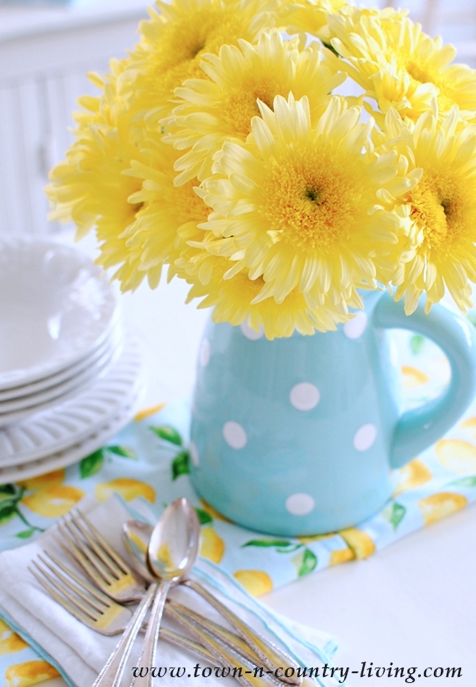 yellow gerbera daisies in polka dot pitcher
