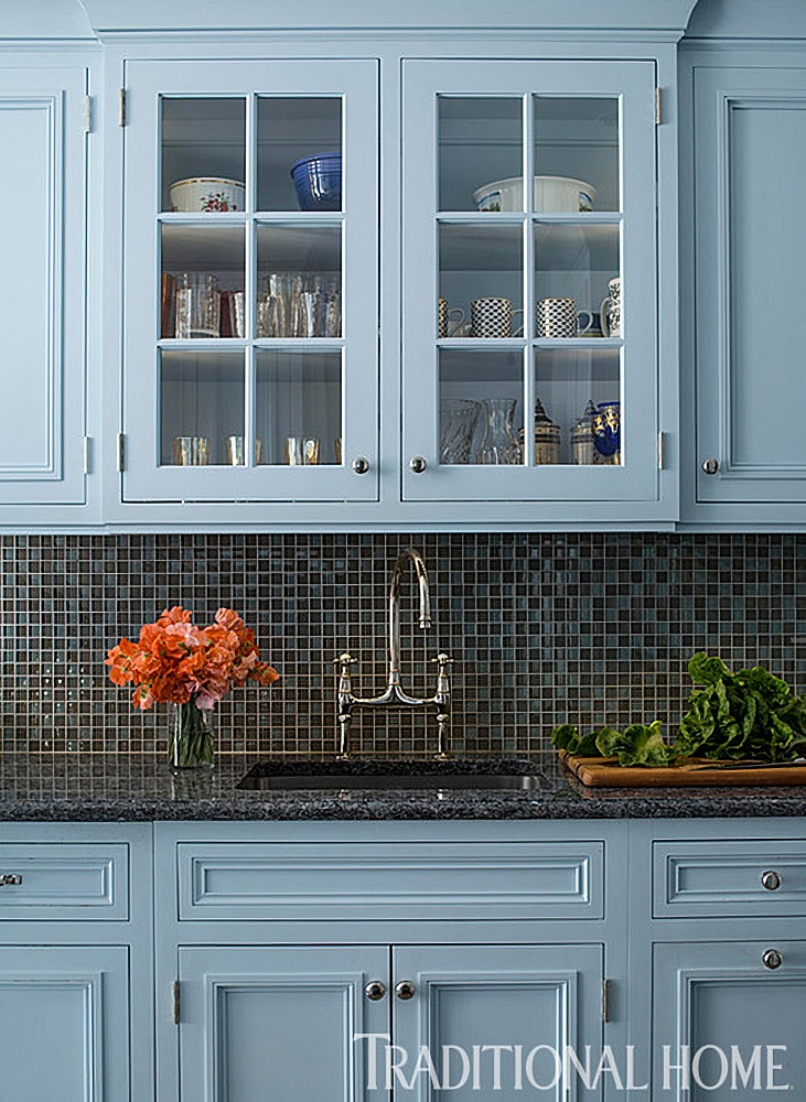 light blue kitchen cabinets with dark gray tile back splash