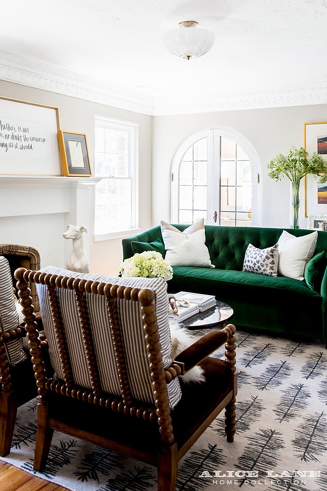 living room with green velvet sofa