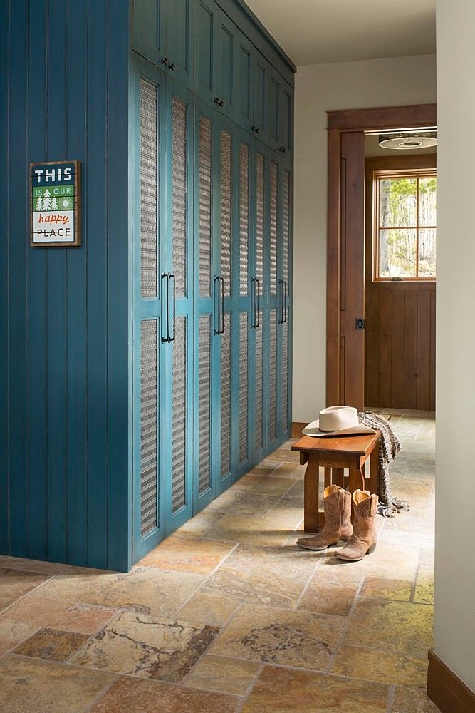 mudroom with blue cabinets and wood trim