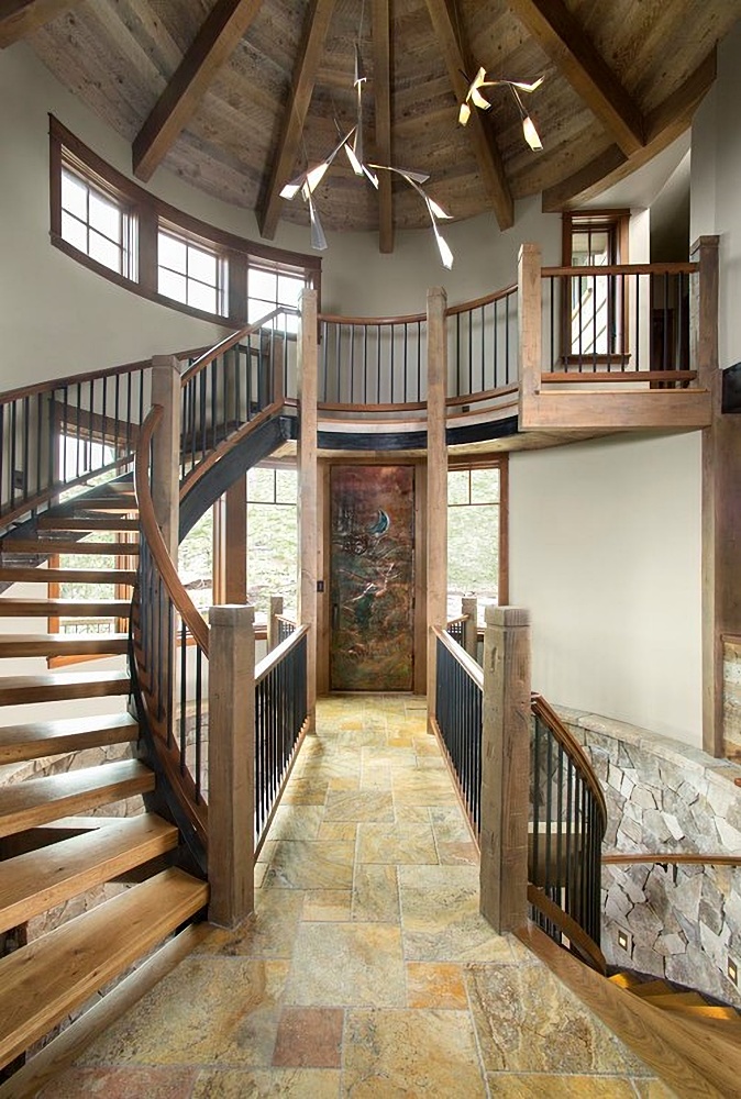 Rustic entryway with custom staircase