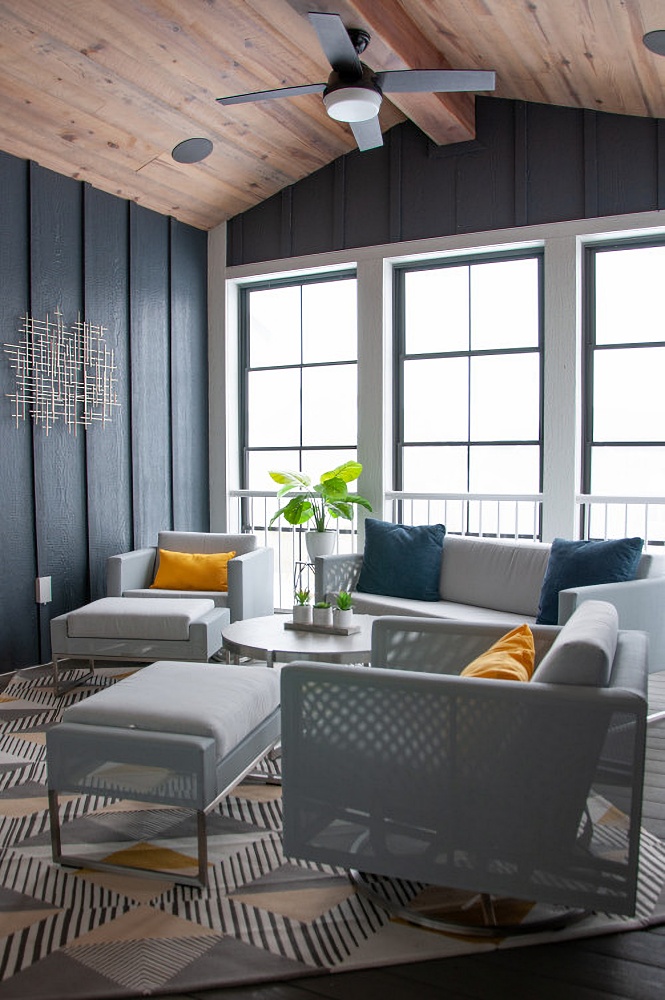 Navy and gray sitting room with big windows