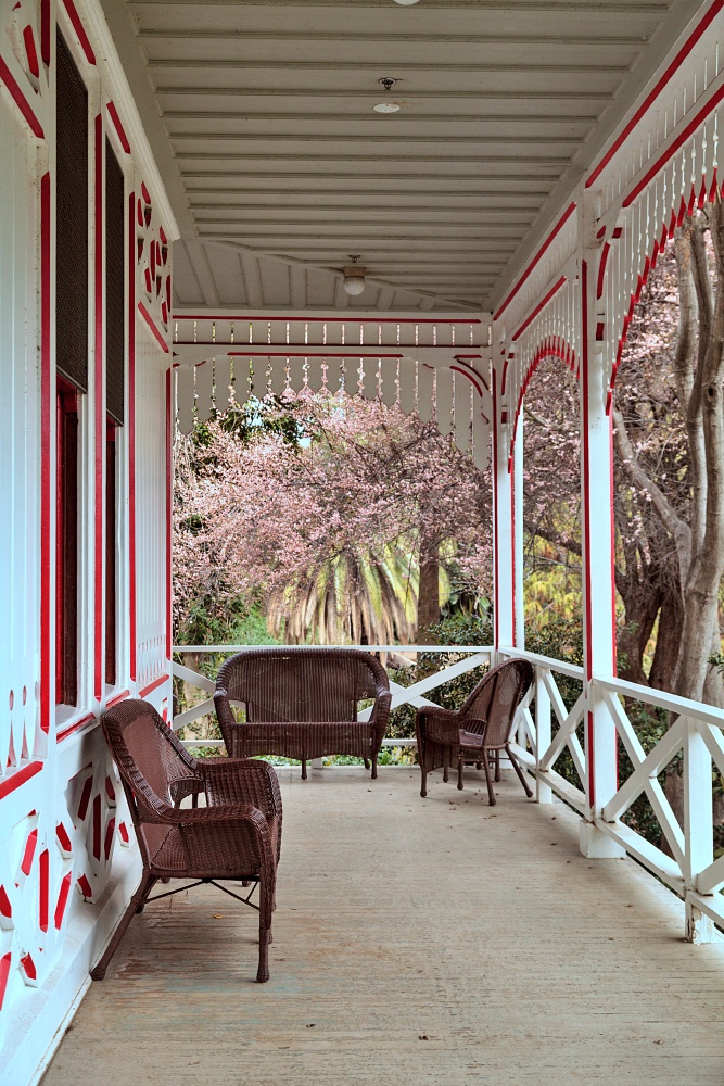 Large Southern Victorian porch with wicker furniture