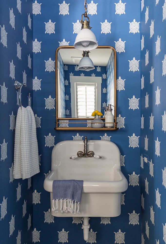 Blue and white turtle wallpaper in a powder room