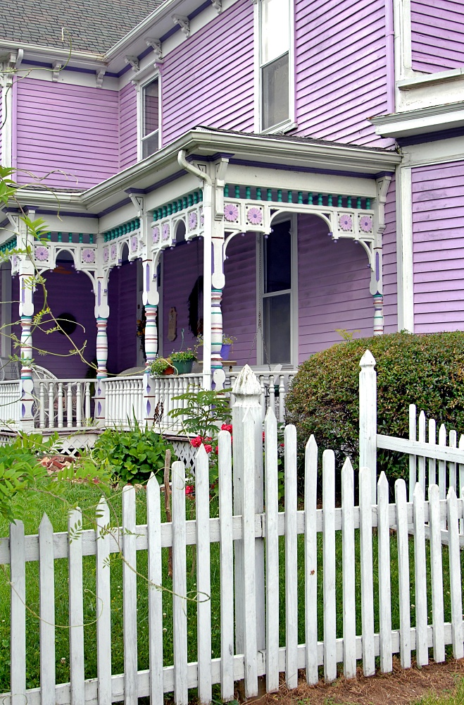 Lavender historic home with picket fence