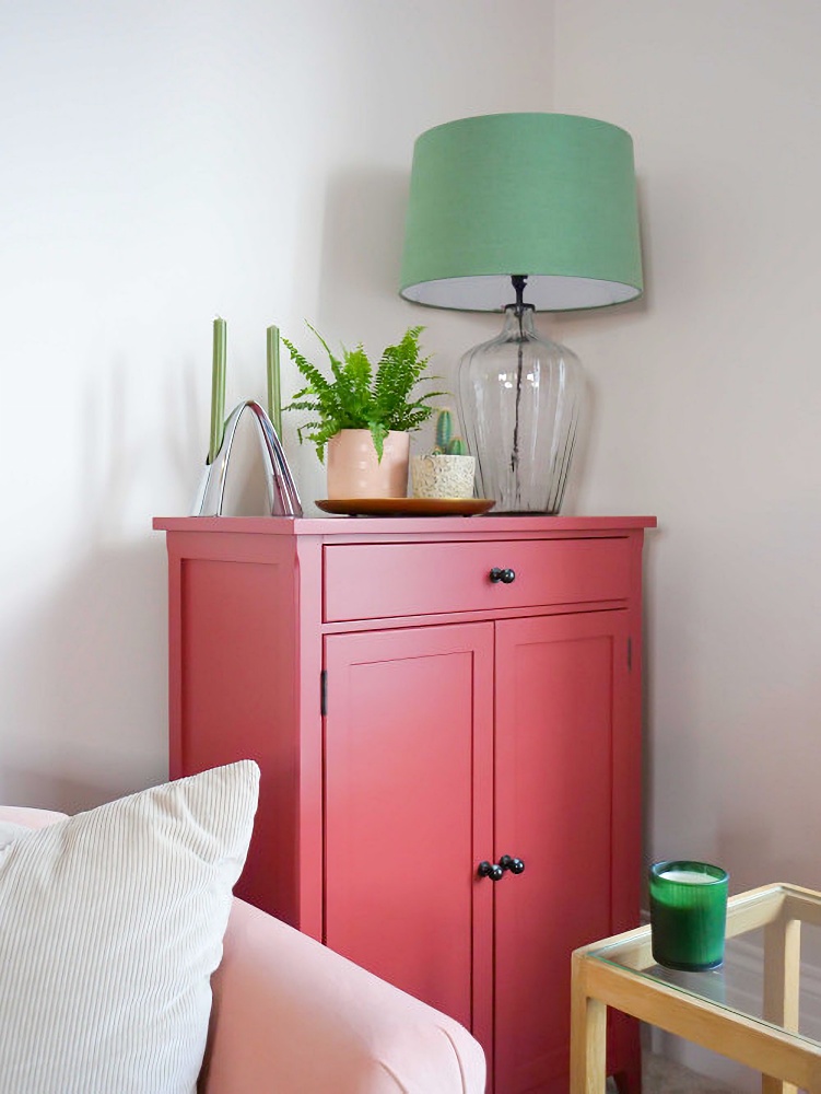 pink cabinet with green lamp
