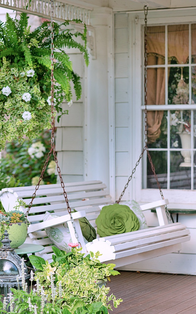 White swing on charming front porch setting 