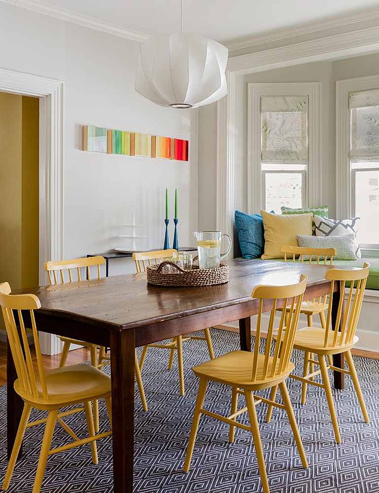 yellow Windsor chairs in colorful dining room