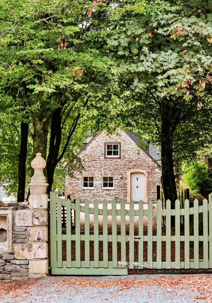 brick cottage with green picket fence