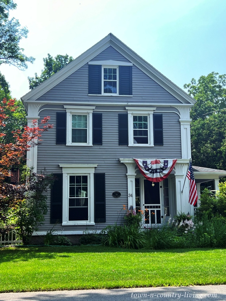 Gray Maine house with patriotic bunting