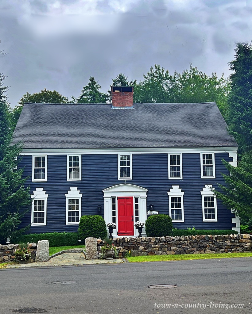 Navy blue historic home with red front door