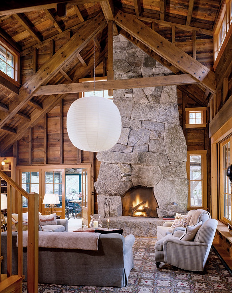 rustic cabin living room with large stone fireplace