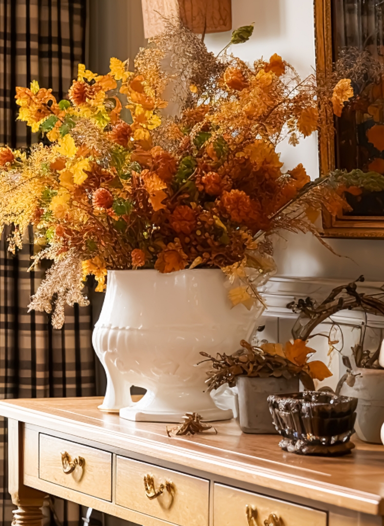 large bunch of dried flowers and fall leaves in white ironstone pot