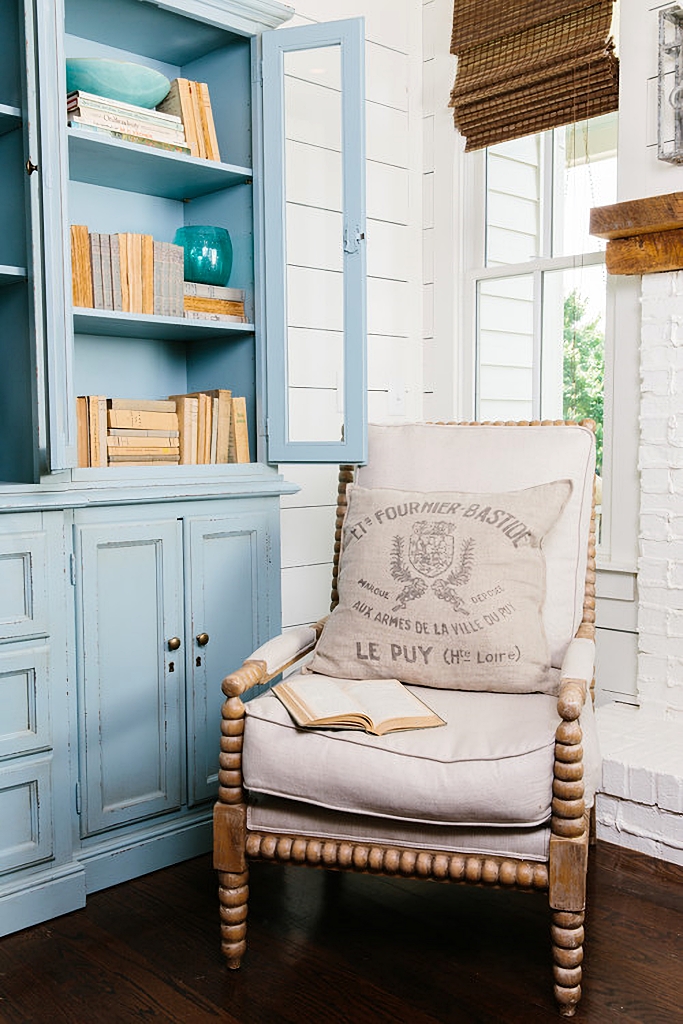 Jenny Lind chair next to blue vintage book case