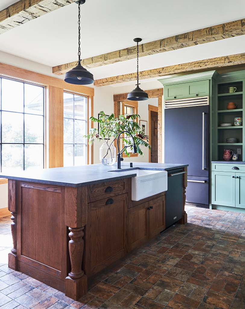 country kitchen with green cabinets and brick floor