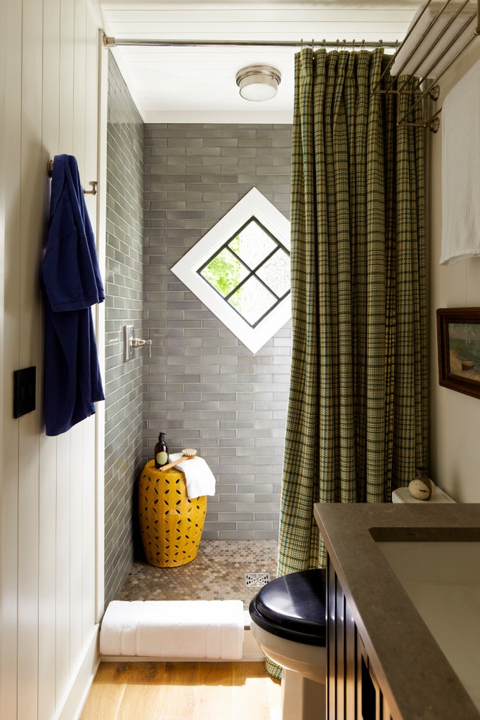 small bathroom with green/grey plaid shower curtain