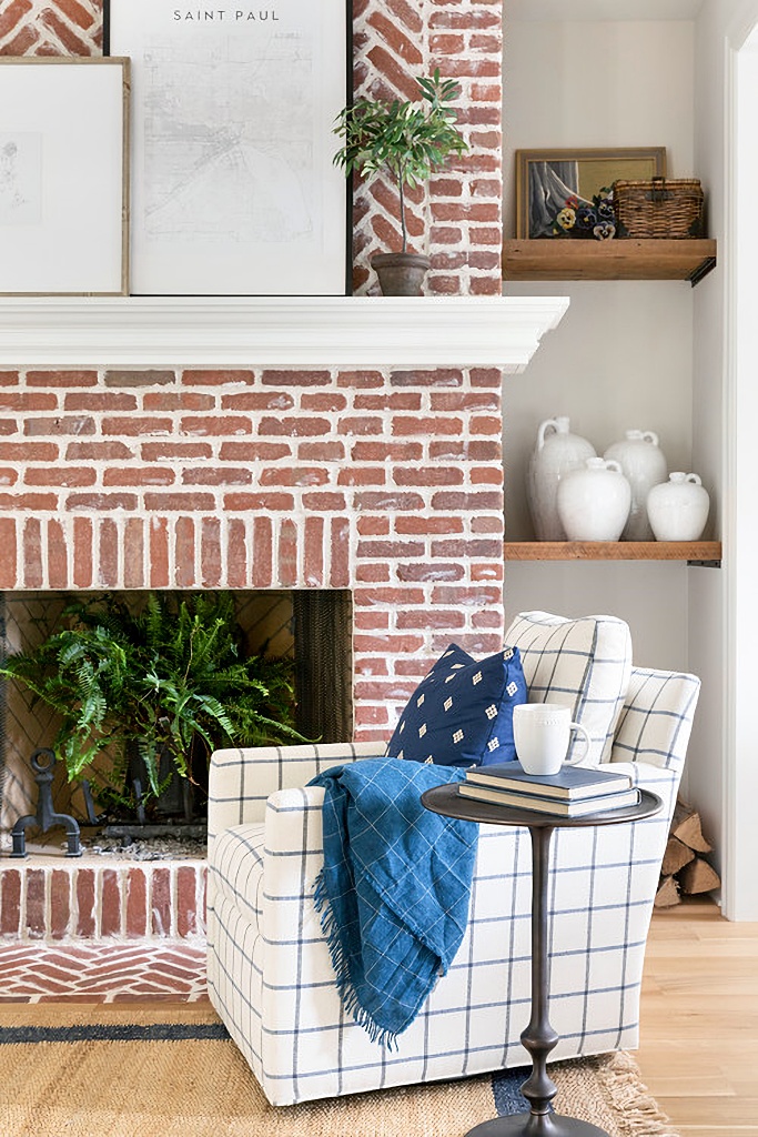 red brick fireplace with white mantel