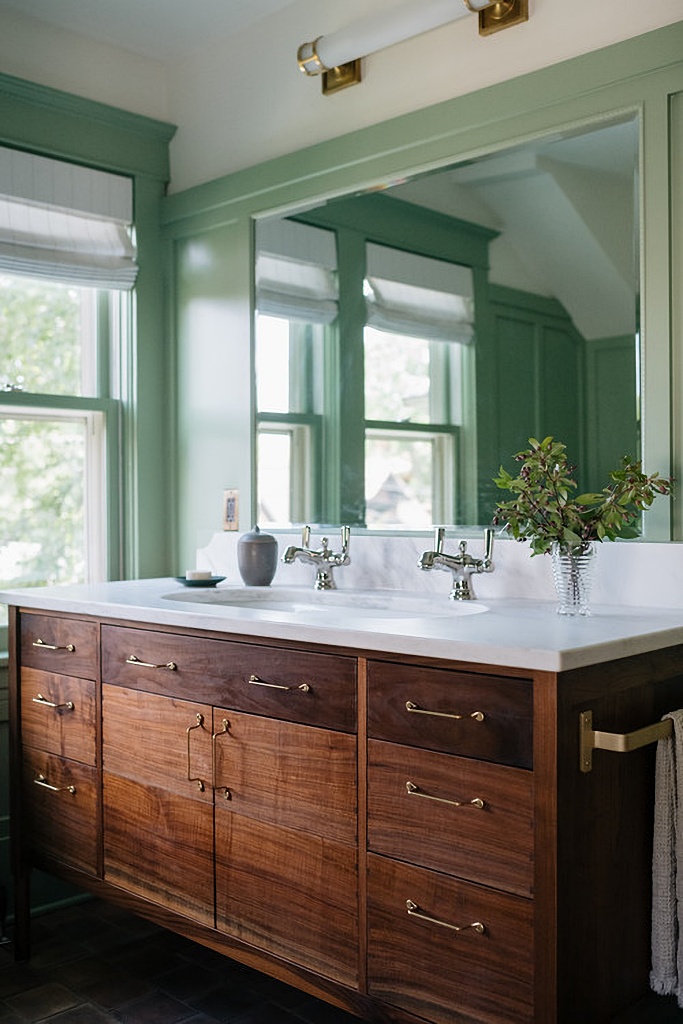 wood vanity in sage green master suite