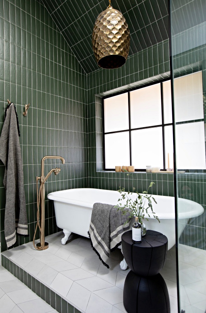 dark green tile and white claw foot tub