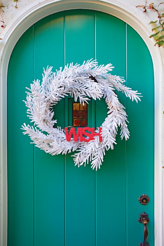 Christmas cottage door with white wreath