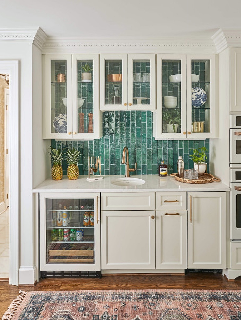 bar area in kitchen with glossy green subway tile