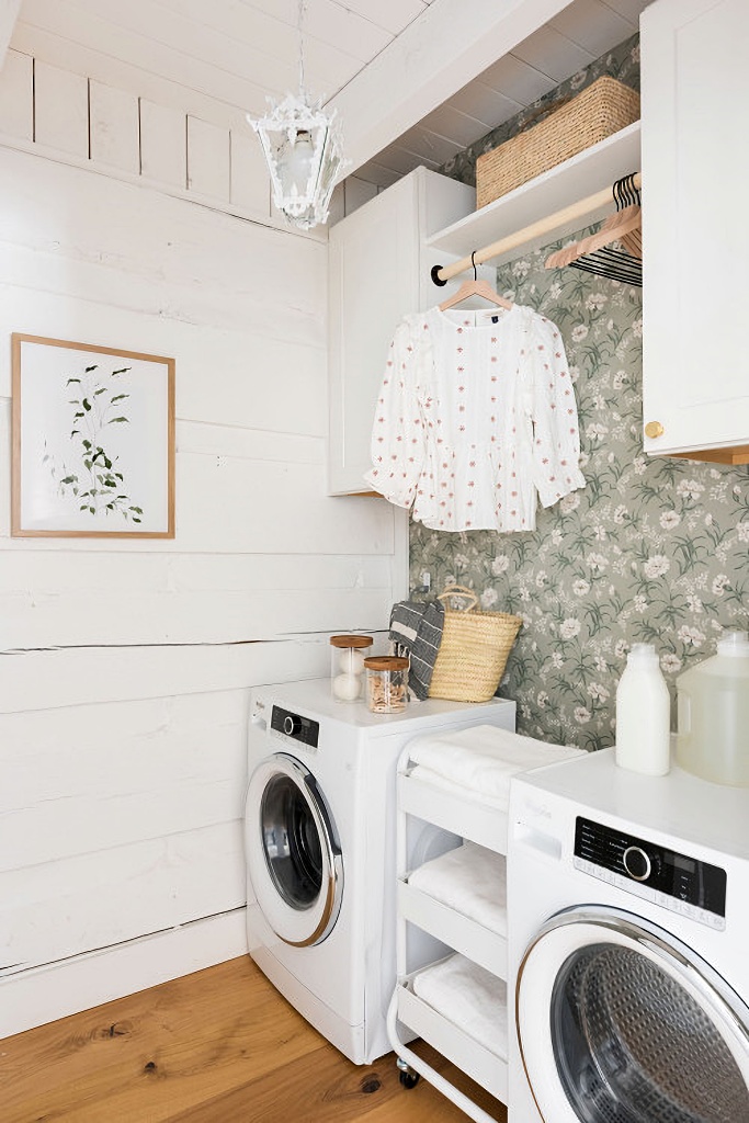 white rough hewn walls in laundry room with wallpaper