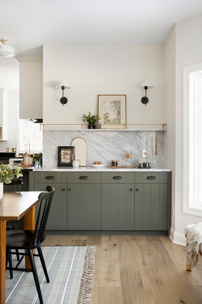 green cabinets with white and gray marble counter top in snug cottage