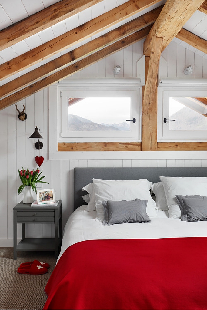 Scandinavian style bedroom in red, white, and gray
