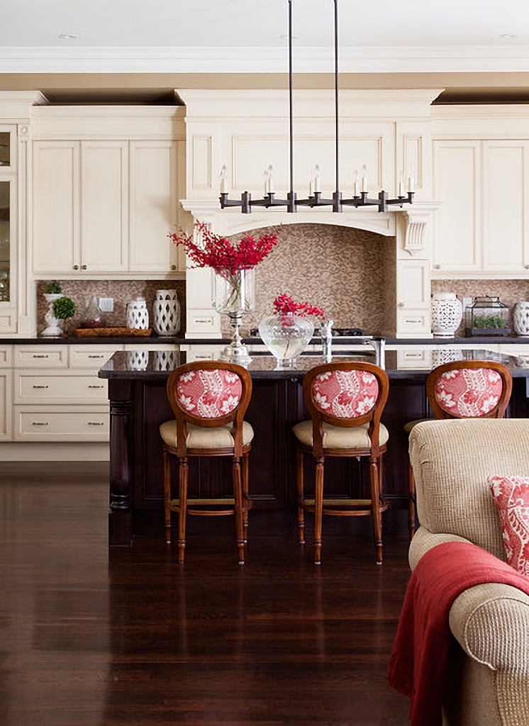 Traditional kitchen with cream cabinets and red accents