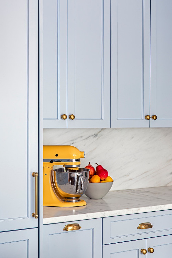 Yellow Kitchen Aid mixer in blue kitchen