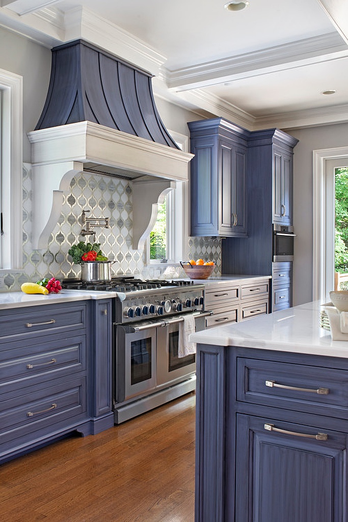 custom range hood in blue kitchen