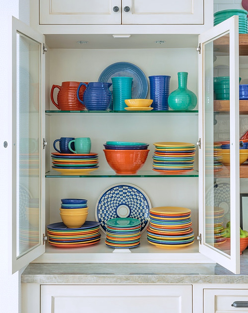 colorful pottery display on kitchen shelves