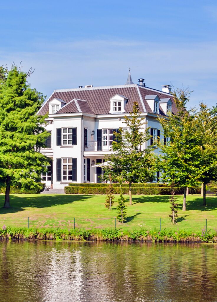 historic mansion on the waterfront in the summertime