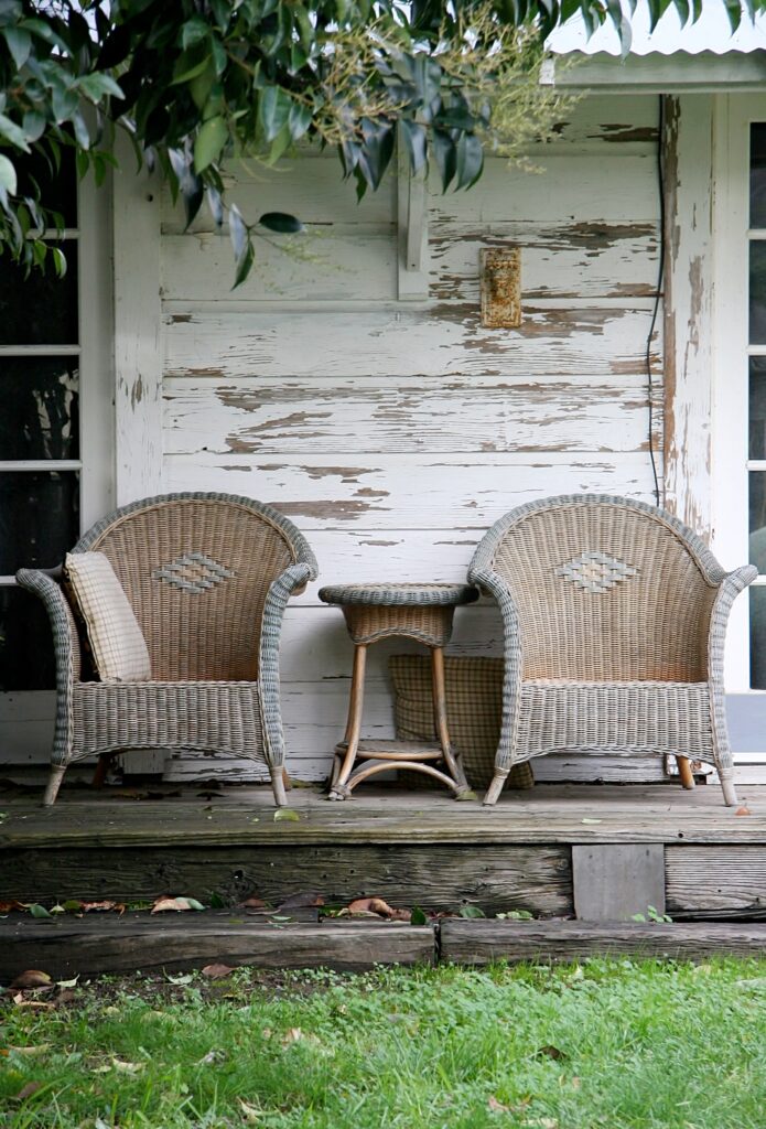 Old wicker chairs on front porch