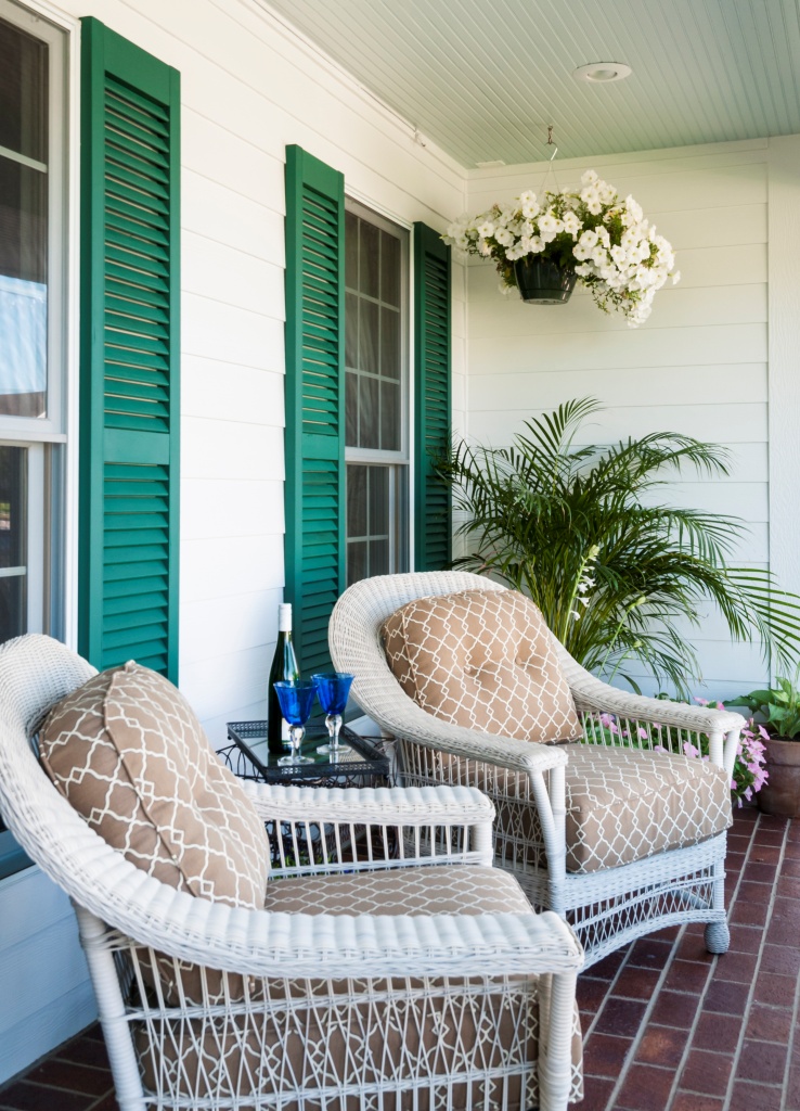 Two comfortable wicker chairs await evening relaxation.