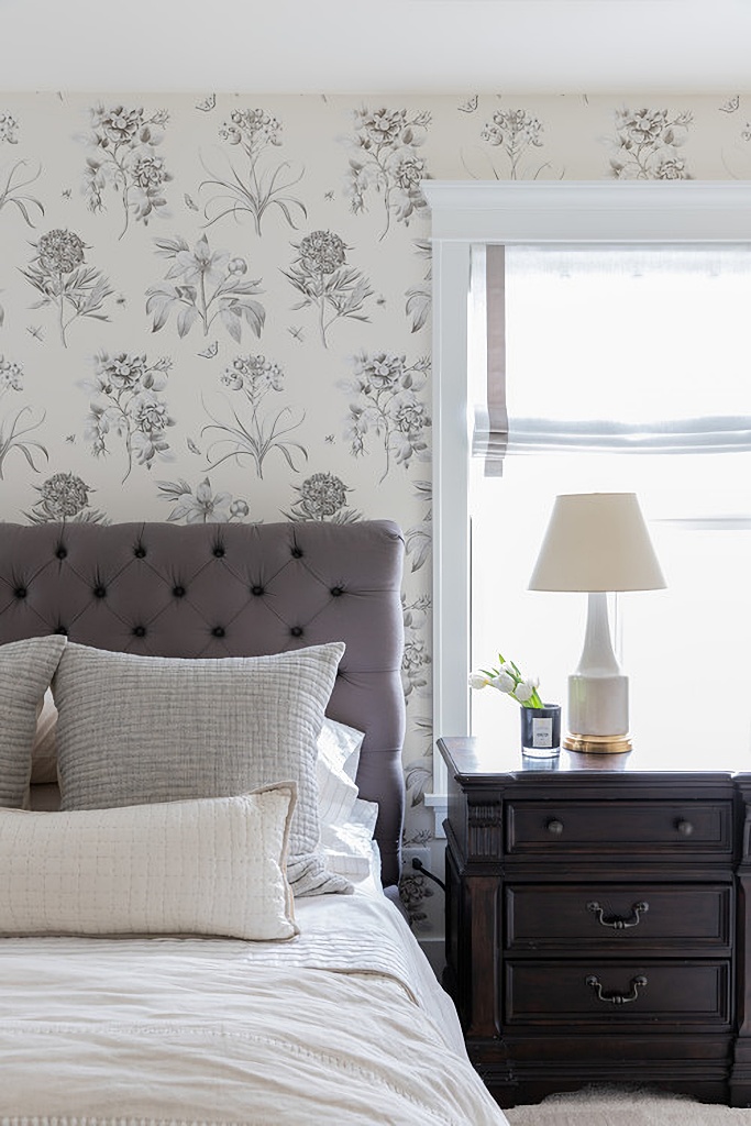 gray and white bedroom with botanical print wallpaper