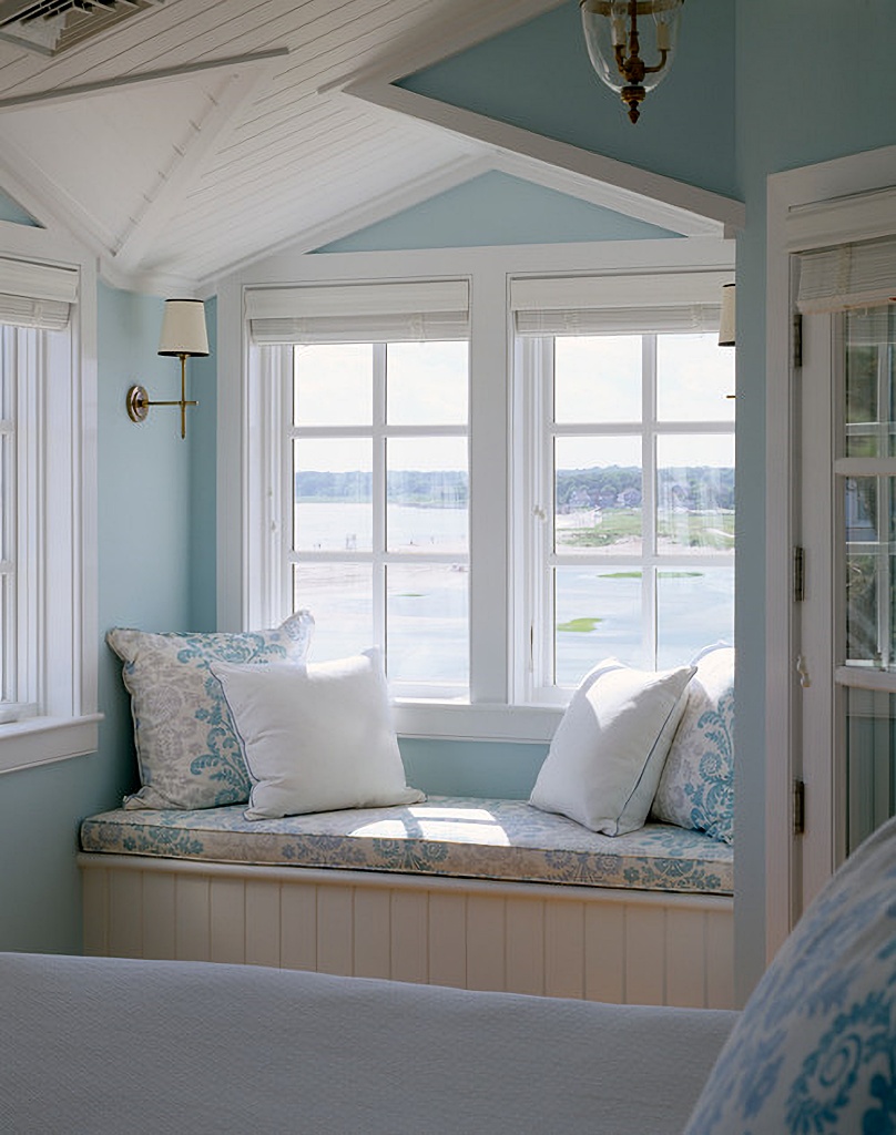 blue and white bedroom with waterfront view