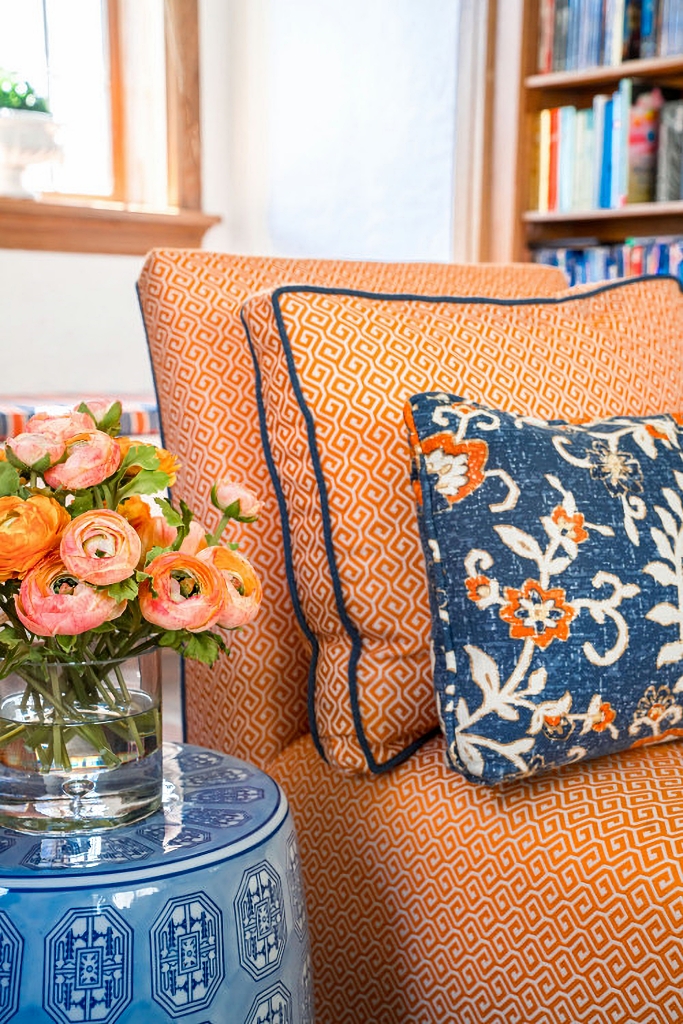 orange upholstered armchair with blue pillow