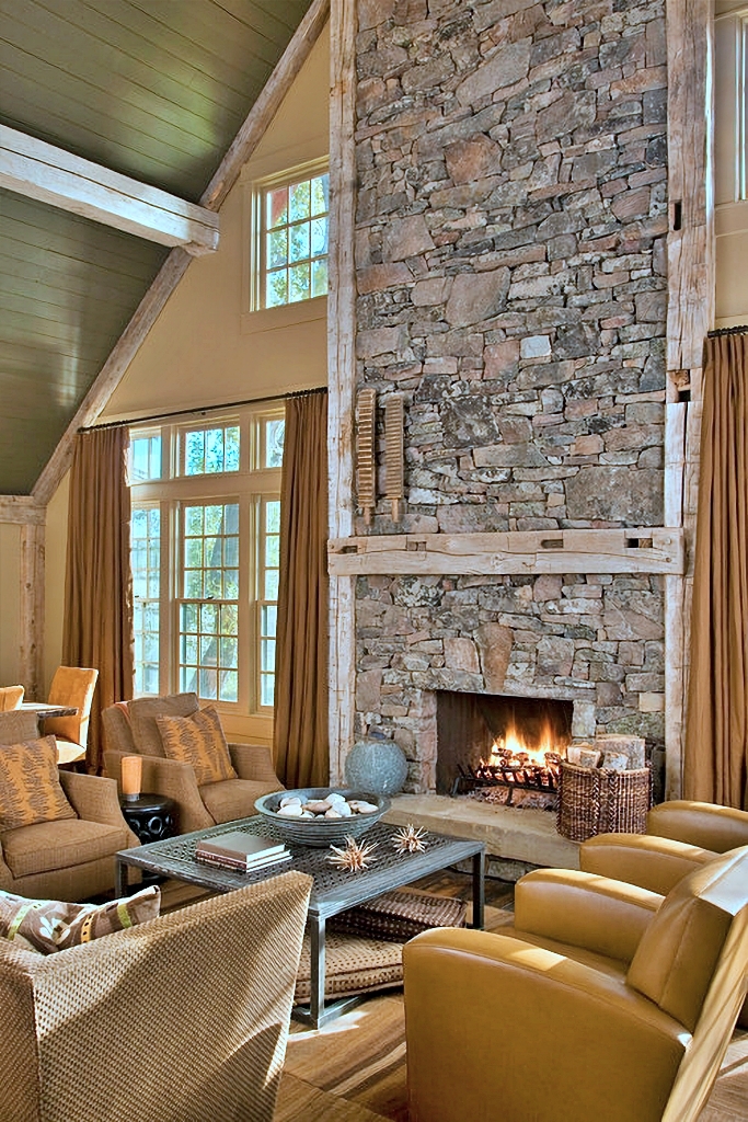 rustic living room with stone fireplace