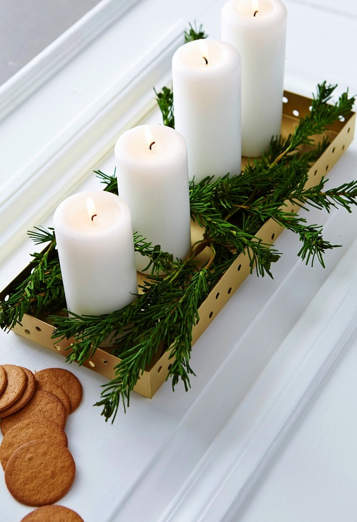 candles and evergreens in box