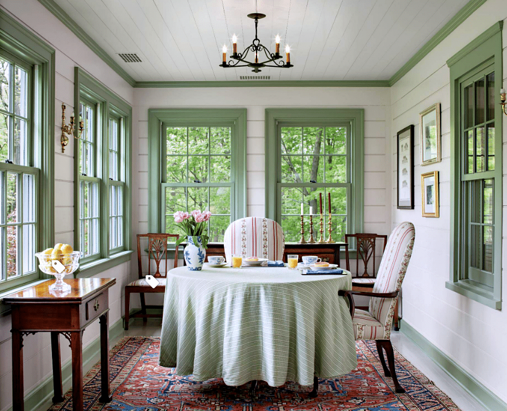 sage green painted trim in porch dining room