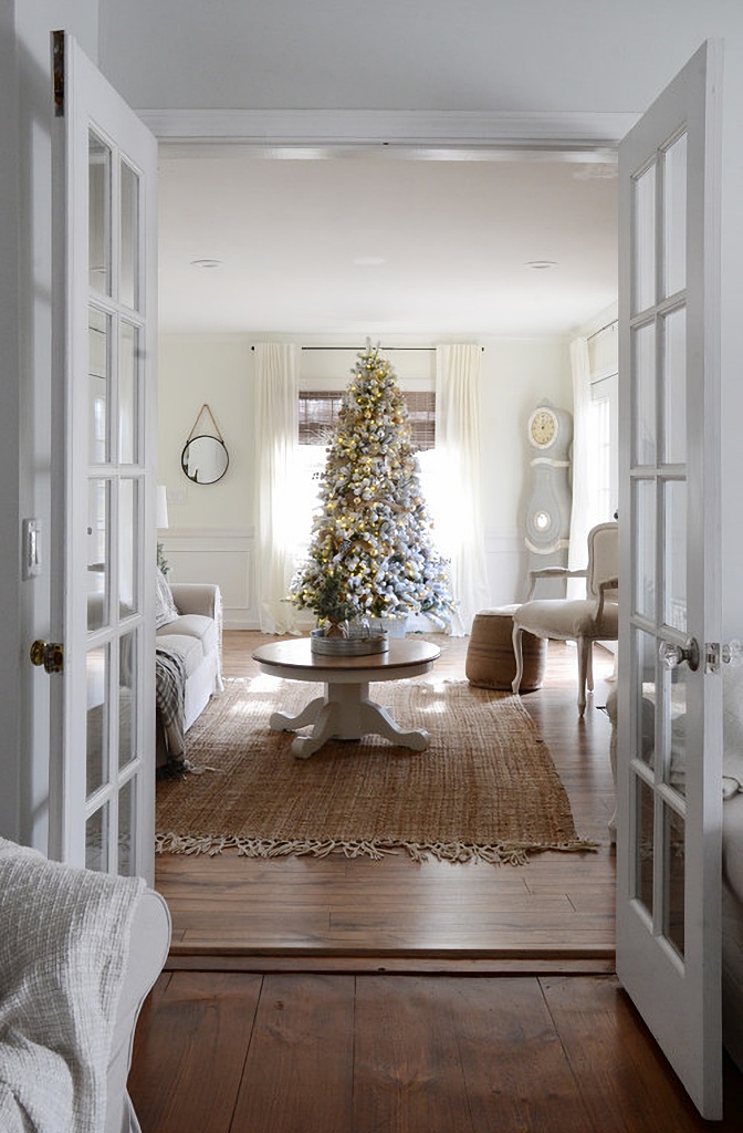 Wood floors in a neutral living room with French doors