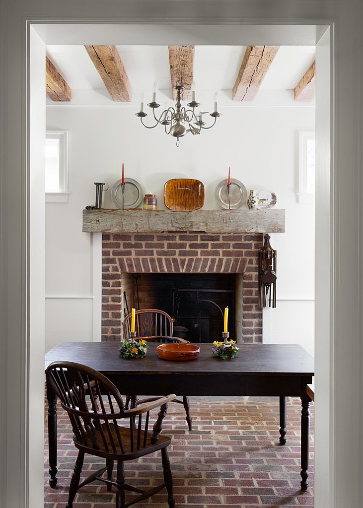 cozy dining room with brick fireplace