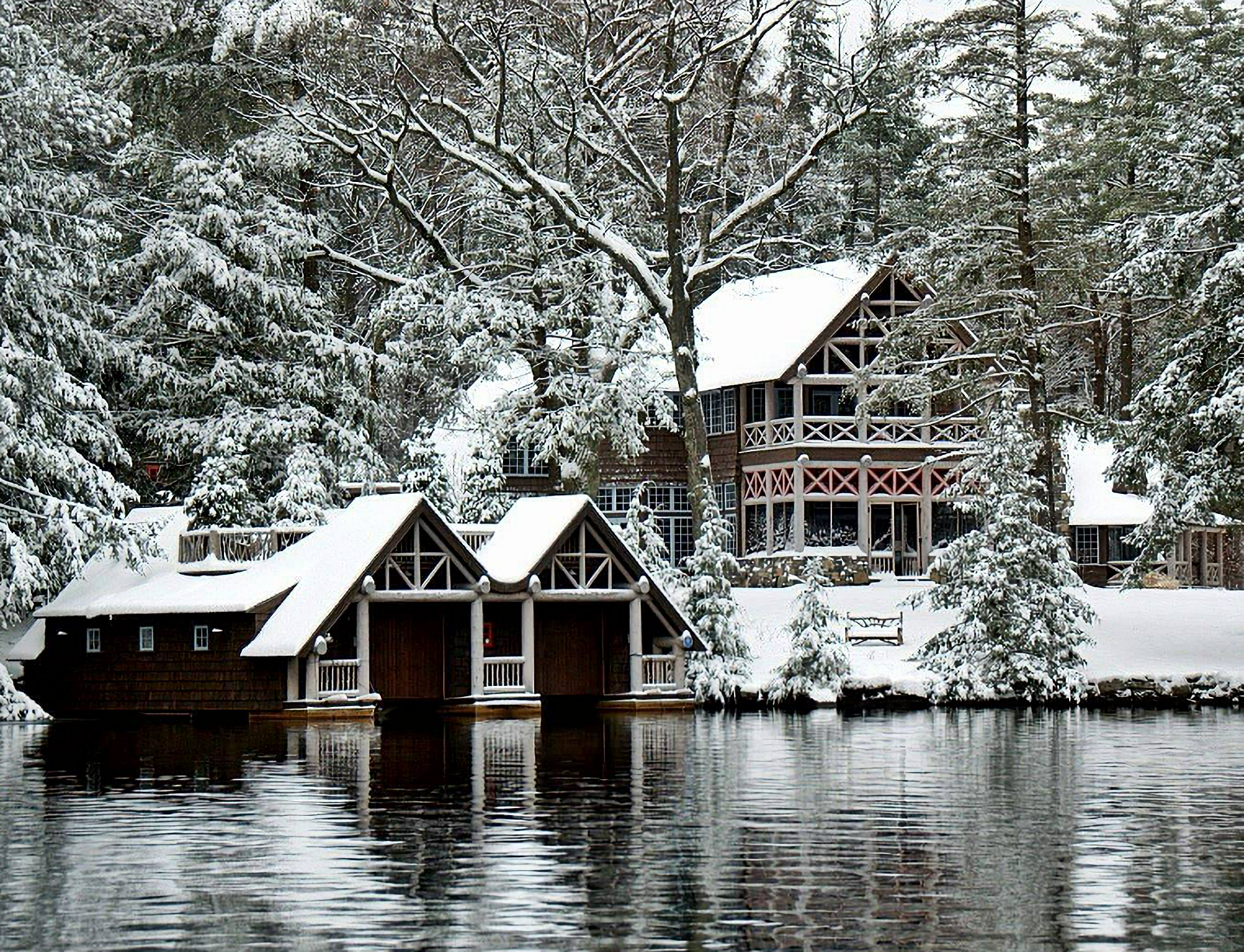 rustic lakeside home in snow