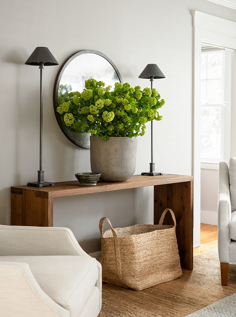 large floral arrangement in stone pottery in neutral living room