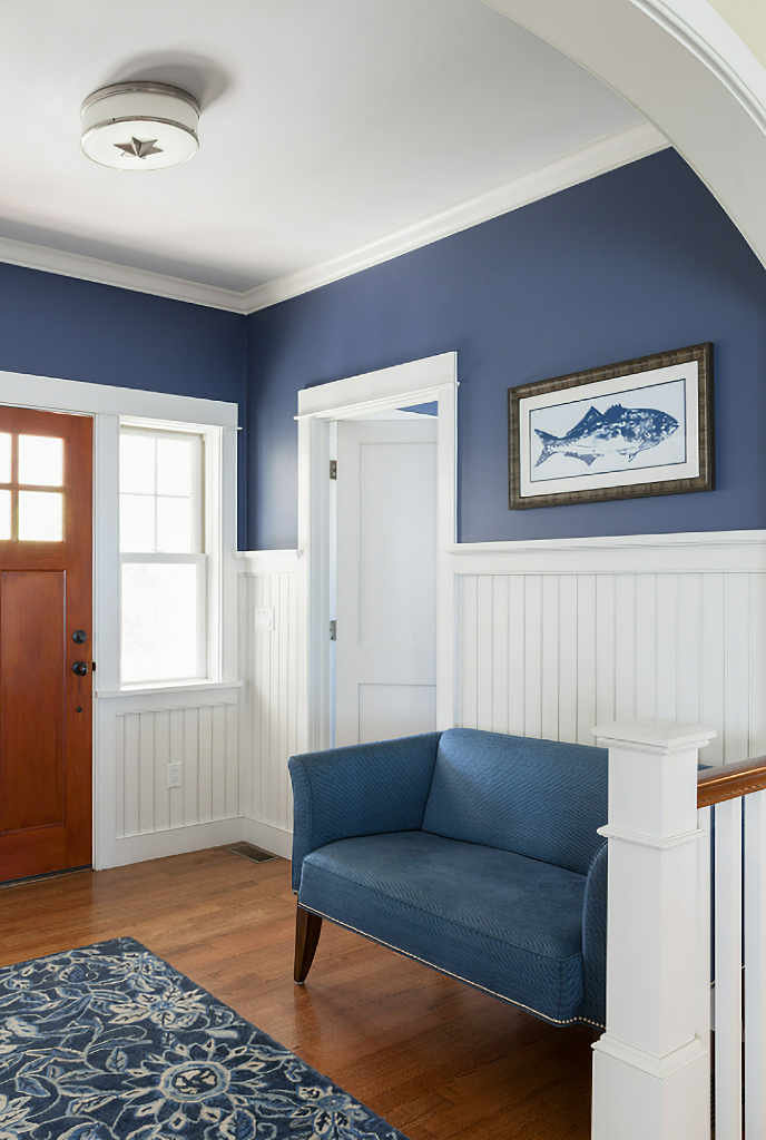 blue and white entryway with loveseat