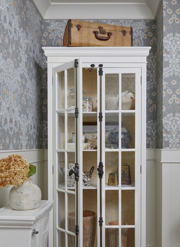 vintage glass front cabinet in powder room