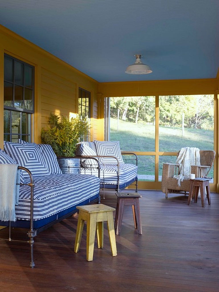 screened porch with vintage daybeds